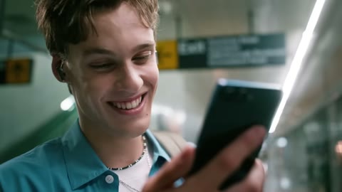 Beat 28: Man smiles at phone